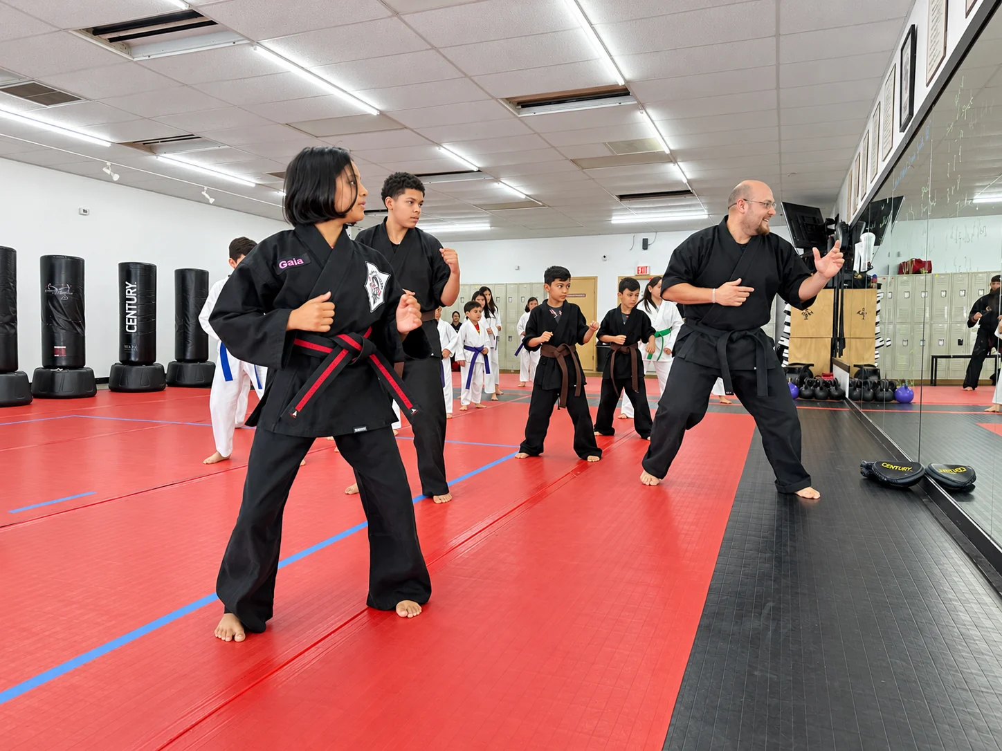 Legacy students and their instructor practicing martial arts together in the dojo